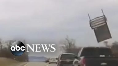 Chair flies out of pickup and strikes police vehicle