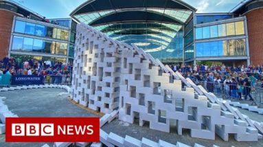 Giant concrete dominoes fall to start UK festival - BBC News