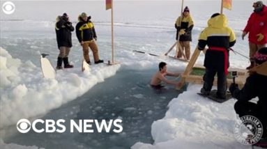 Antarctic expeditioners plunge into icy water for mid-winter swim