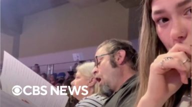 Grandpa cheers for every kid at graduation