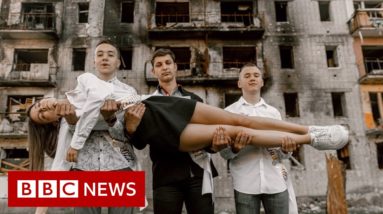 Ukraine high school students pose in prom dresses among ruins - BBC News