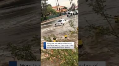 Car pushes through floods